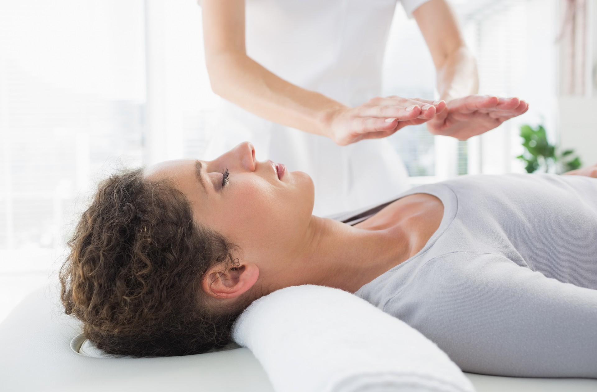 Woman having reiki treatment